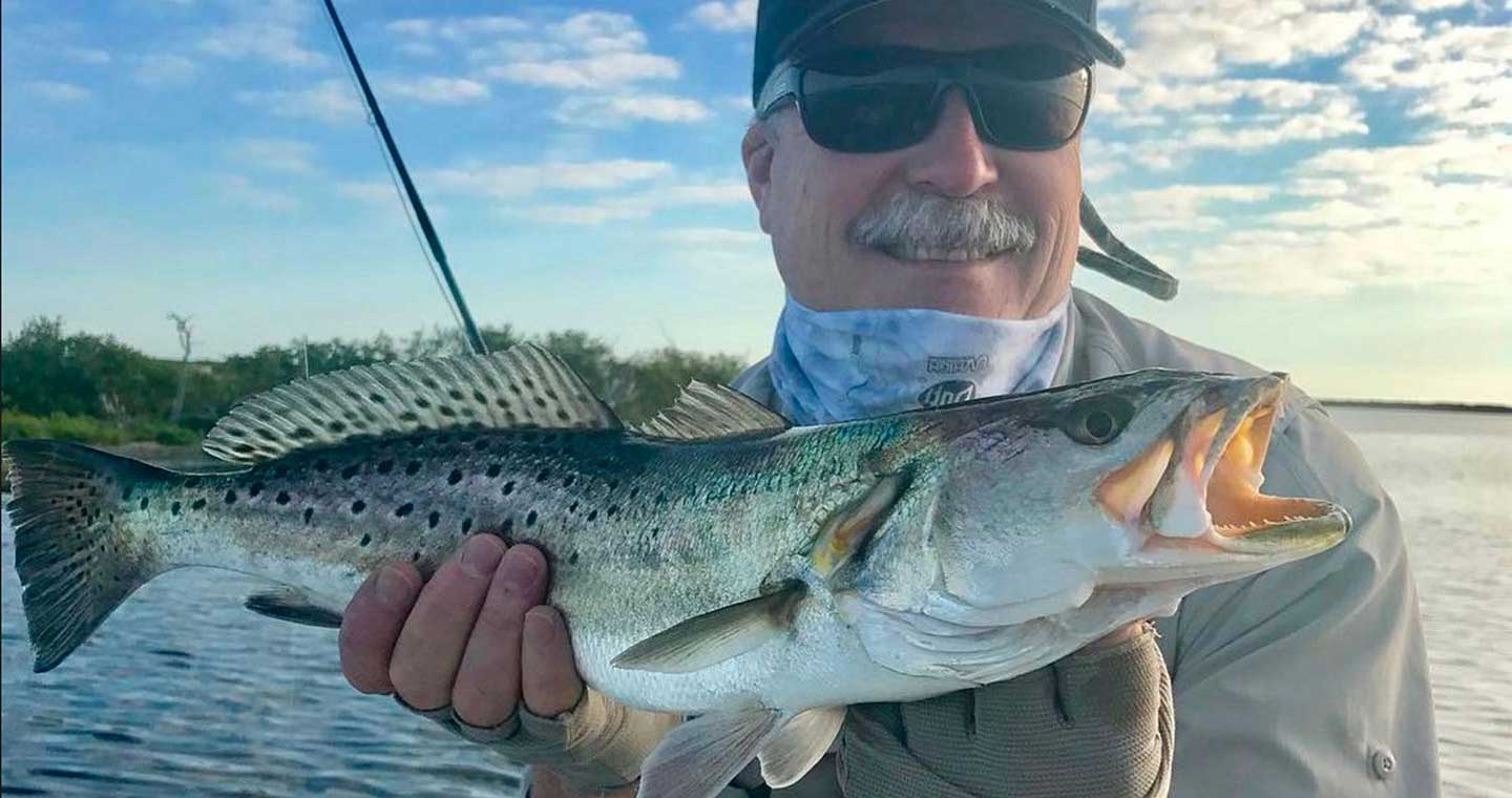 Man holding trout at the Inshore Fishing Charter in Cocoa Beach