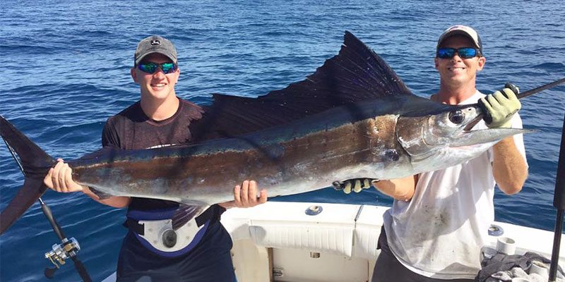 Men Holding Kingfish on a Deep Sea Fishing Charter in Port Canaveral